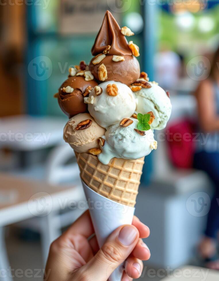 Ice cream cone topped with assorted flavors and nuts enjoyed in a vibrant cafe setting photo