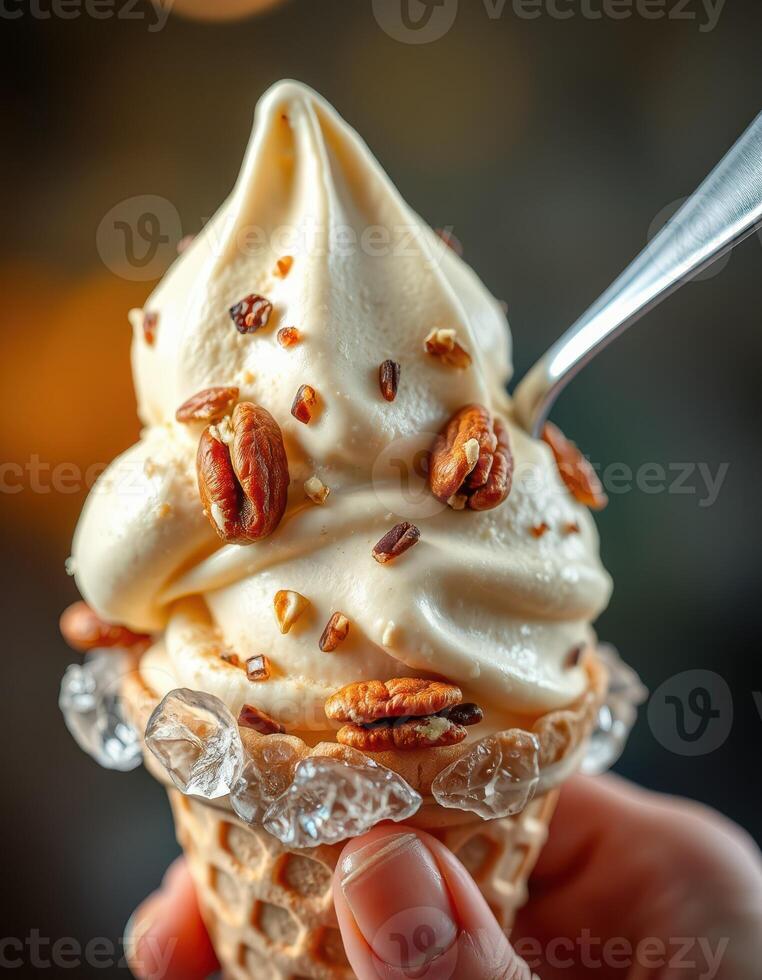 Delicious soft serve ice cream topped with pecans served in a cone during a warm sunset evening photo