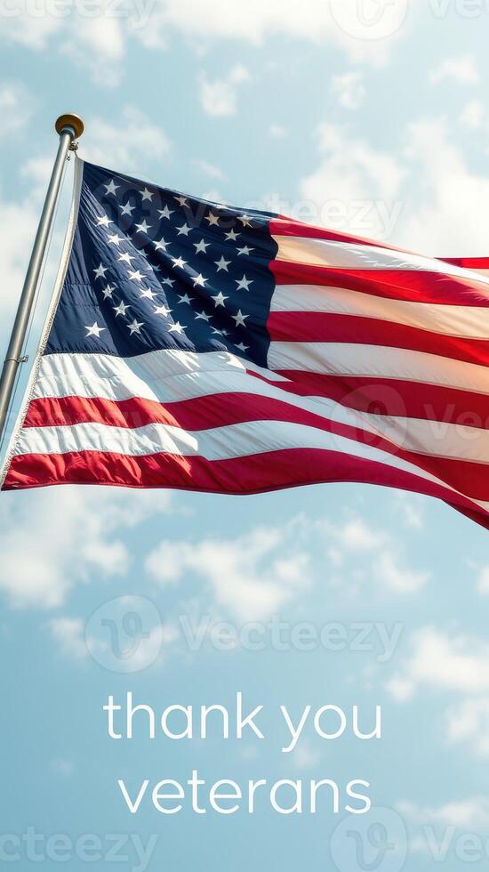 American flag waving in the sky with a message honoring veterans during a bright day photo