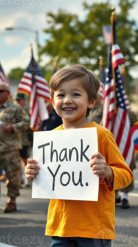 Young child expresses gratitude with sign during a patriotic parade honoring veterans in a festive downtown setting photo