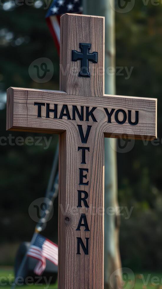 Wooden cross with message honoring veterans displayed outdoors in a serene setting photo