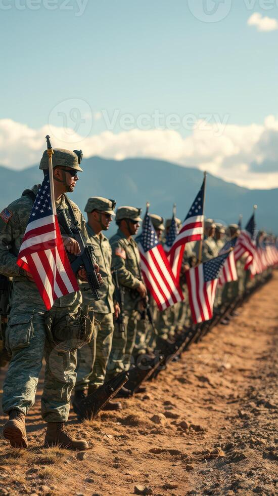 Soldiers stand in formation with American flags during a military ceremony in a scenic location at sunset photo