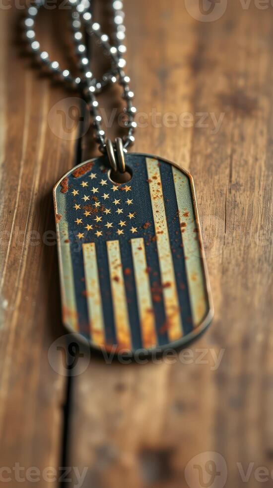 Vintage dog tag with weathered American flag design resting on rustic wooden surface photo