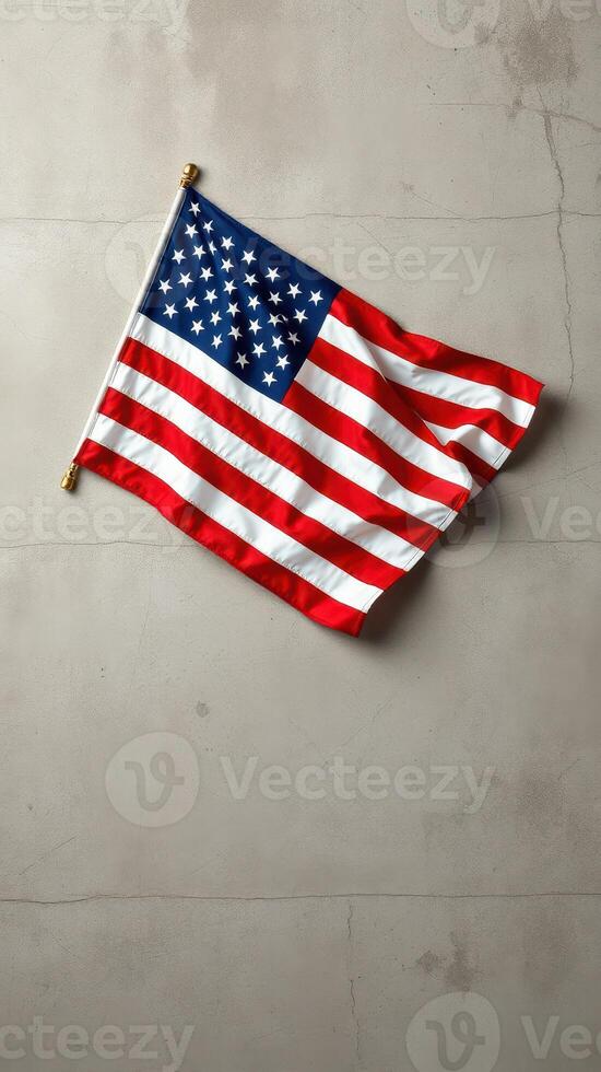 American flag draped against a textured concrete wall in a simplistic and modern setting photo