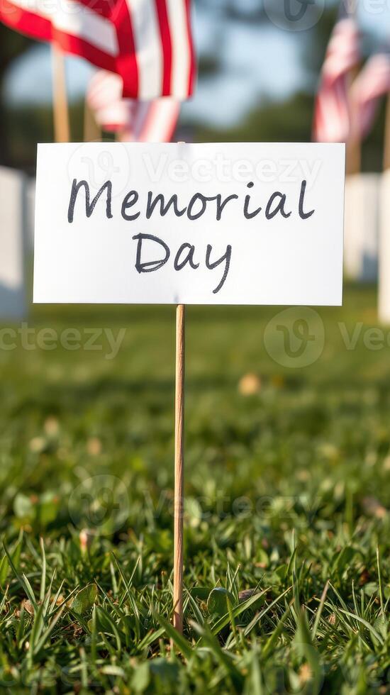Honor and remembrance on Memorial Day with flags and dedication markers in a green park setting photo