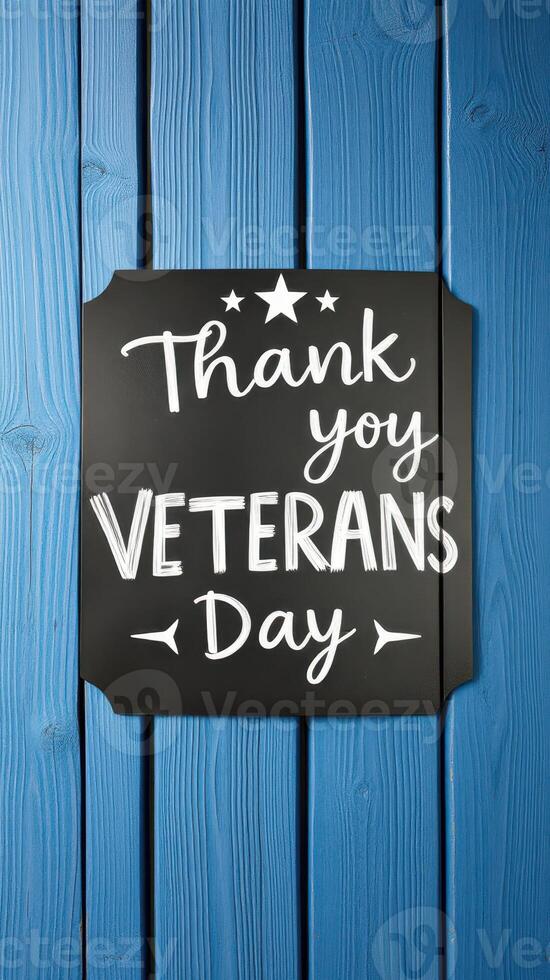 Creative display of a thank you message celebrating Veterans Day on a blue wooden background photo