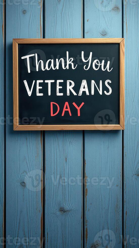 Thank you message for Veterans Day displayed on a chalkboard against a wooden backdrop photo