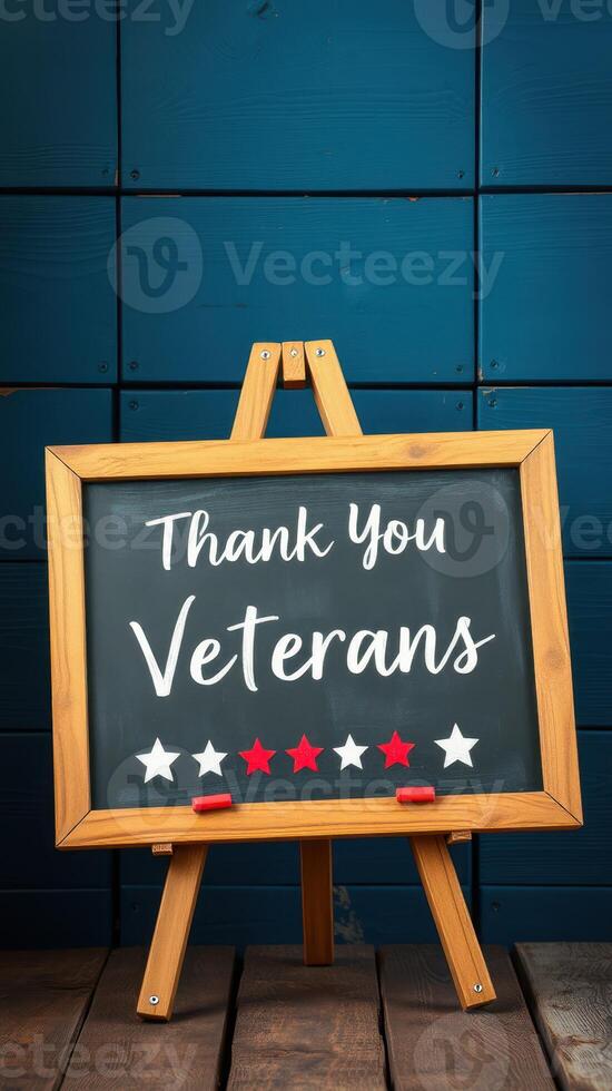 Sign expressing gratitude to veterans displayed on an easel against a blue wall during a commemorative event photo