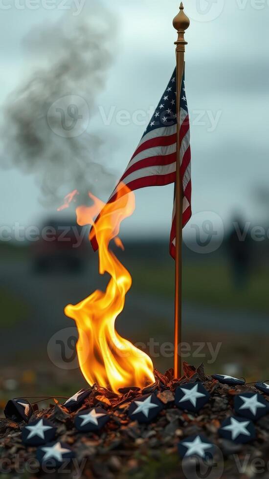 Flames dance around a U.S. flag on a somber day amidst a blurred gathering in the background photo