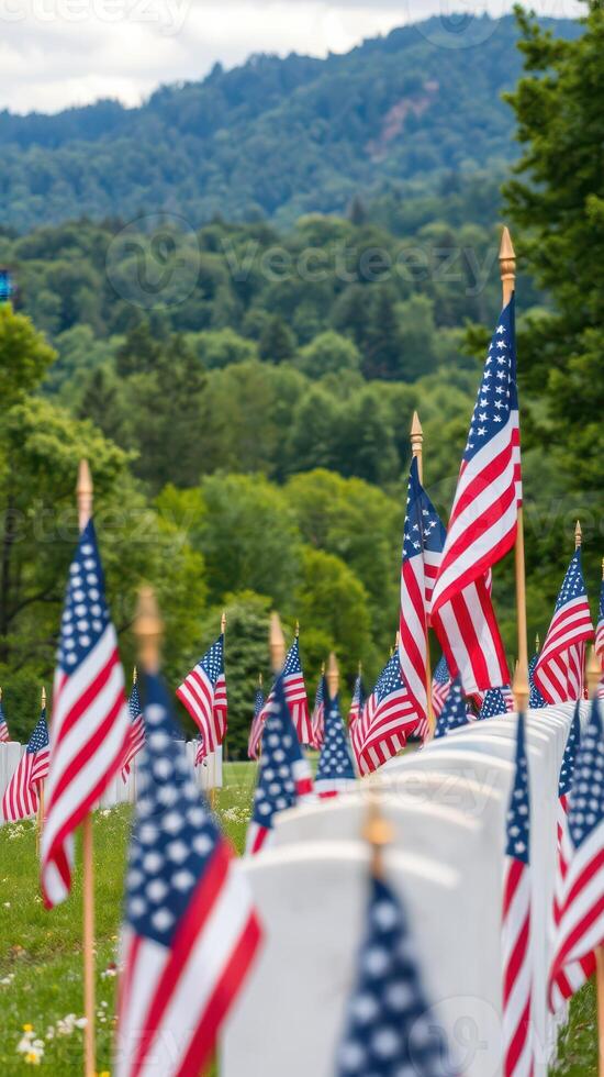 Memorial display of American flags honoring veterans at a cemetery on a clear day surrounded by lush greenery photo