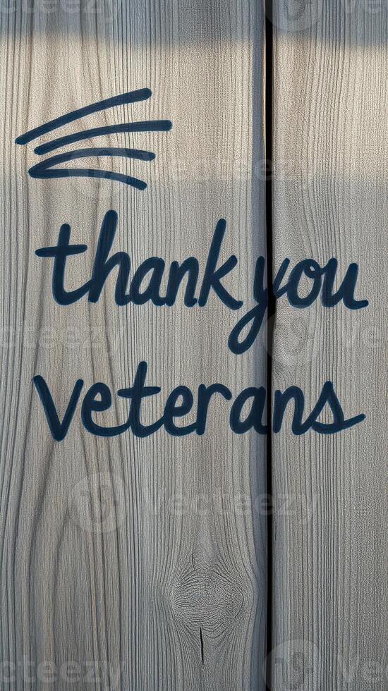 Sign expressing gratitude to veterans displayed on weathered wooden surface to honor their service during a meaningful occasion photo