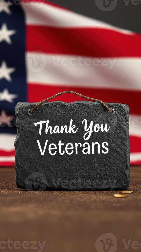 Slate sign with message honoring veterans against background of American flag photo