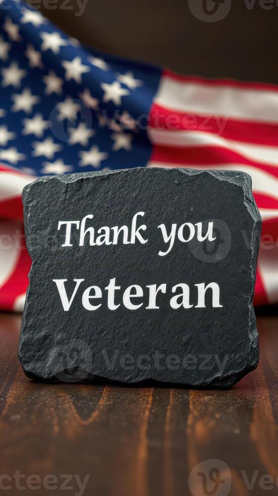 Thank you veteran sign displayed against an American flag background during a commemorative event photo