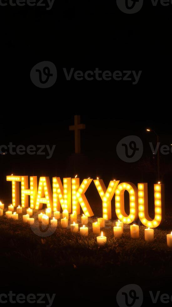 Brightly lit thank you sign surrounded by candles at night, conveying gratitude and appreciation in a serene setting photo