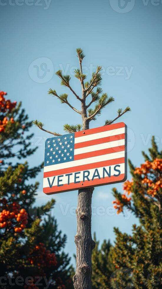 Veterans sign displayed against a backdrop of trees and vibrant orange foliage during a clear day photo