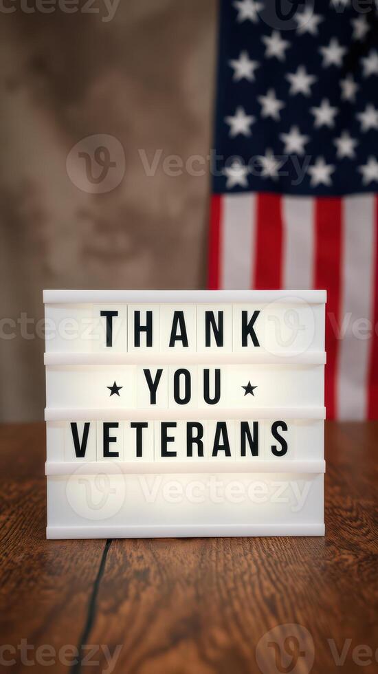 Sign expressing gratitude to veterans with American flag background in a warm indoor setting photo