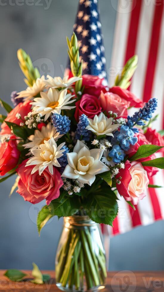 Beautiful floral arrangement with red white blue colors celebrating patriotism in front of an American flag photo