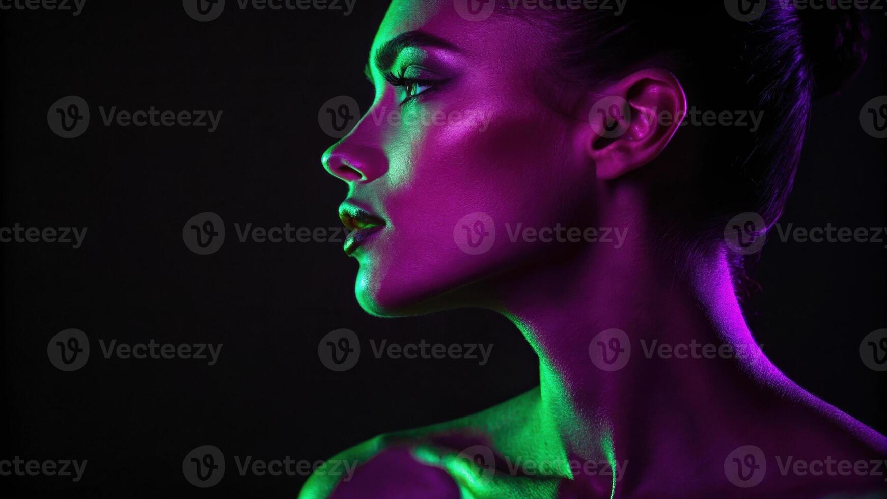 A dramatic profile captures the subjects silhouette one half illuminated in a vibrant green light while the other half glows in a deep rich purple. The interplay of colors. photo