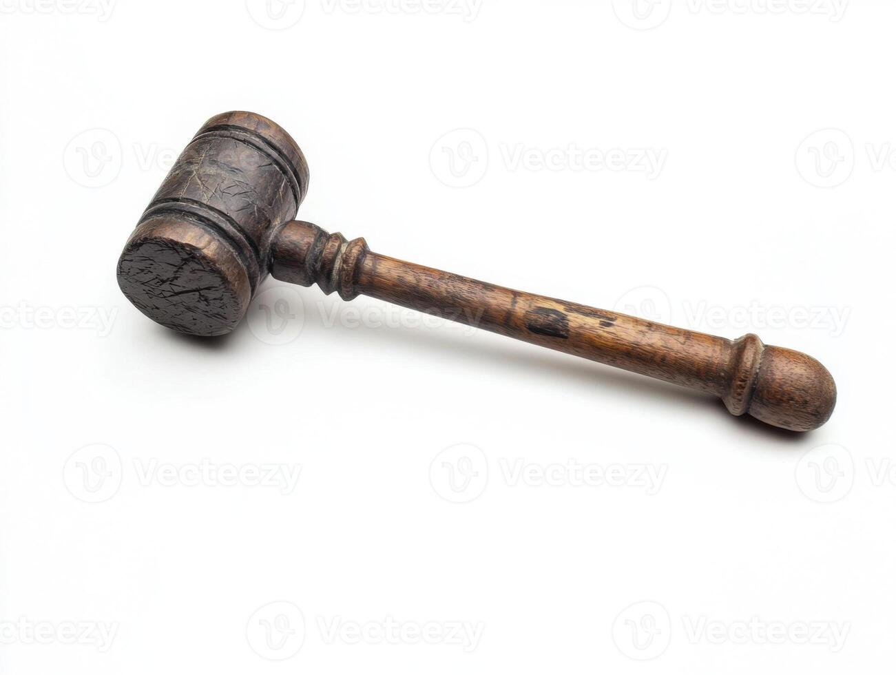Traditional wooden gavel resting on a clean surface with intricate detailing photo