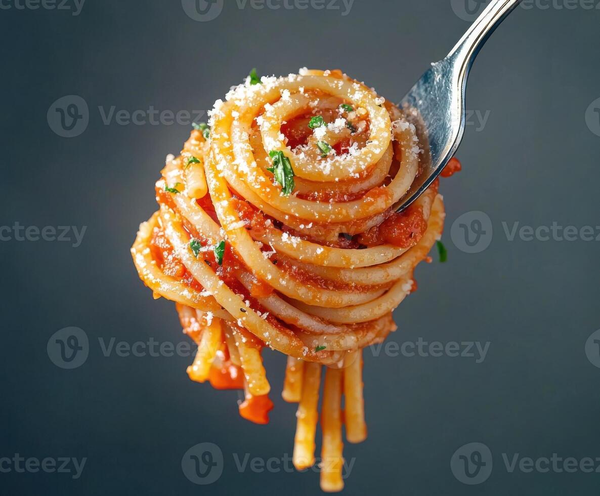 Delicious spaghetti twirled on a fork garnished with herbs and cheese ready to be served photo