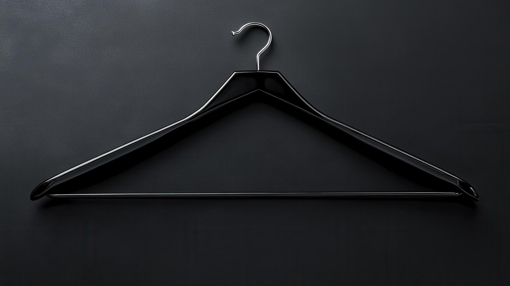 Hanger on a black background creating a minimalist design suitable for fashion displays or textile presentations photo