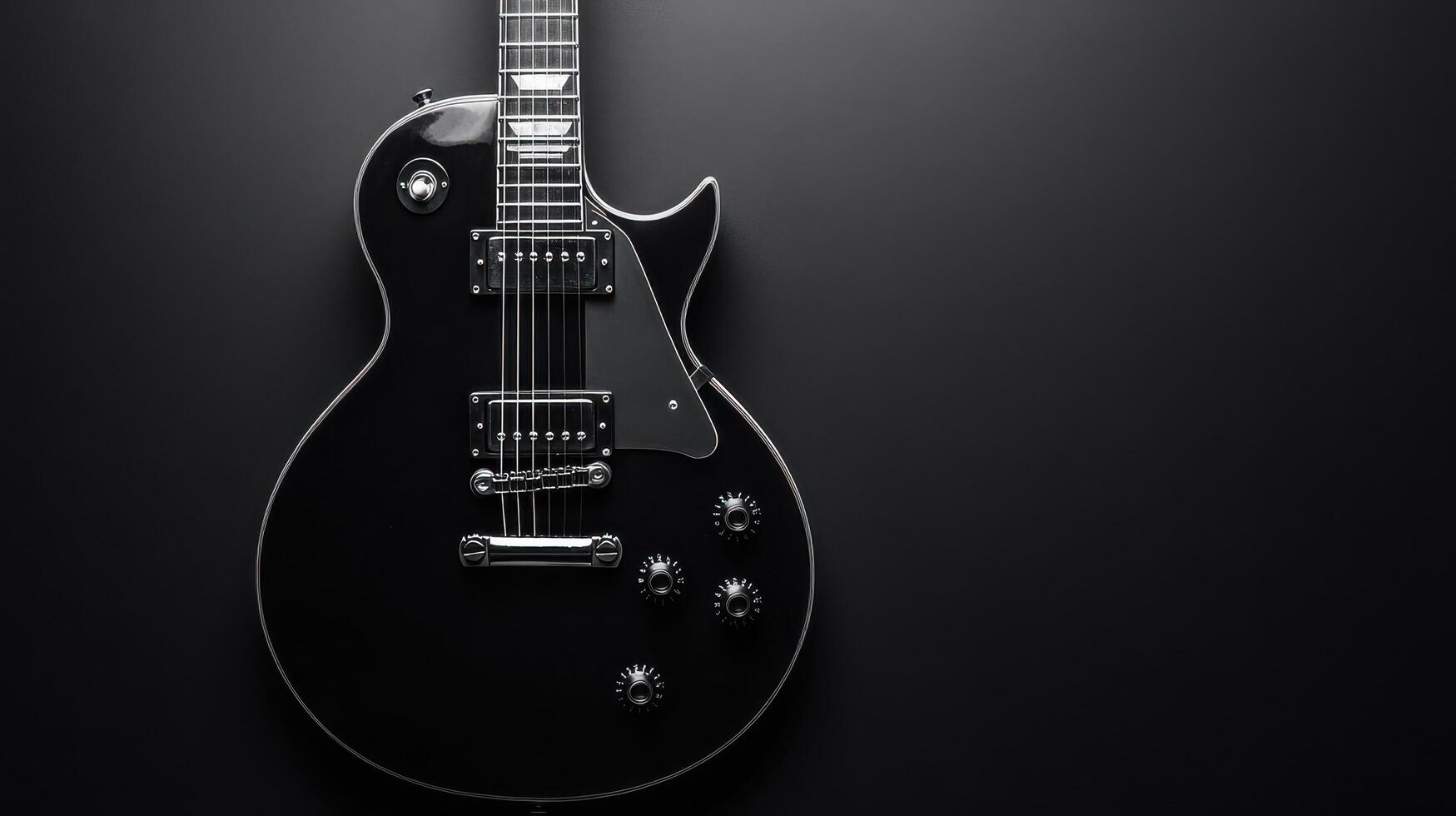Black electric guitar with chrome hardware against a dark background highlighting its sleek design and details photo