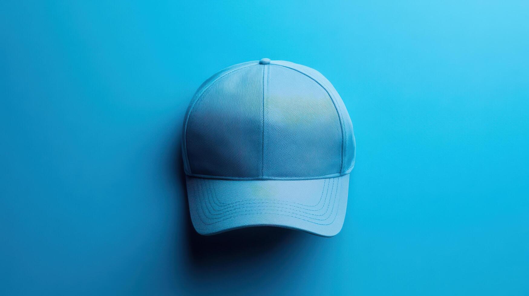 Bright blue cap laid flat on a smooth turquoise surface creating a minimalist aesthetic in a well-lit setting photo