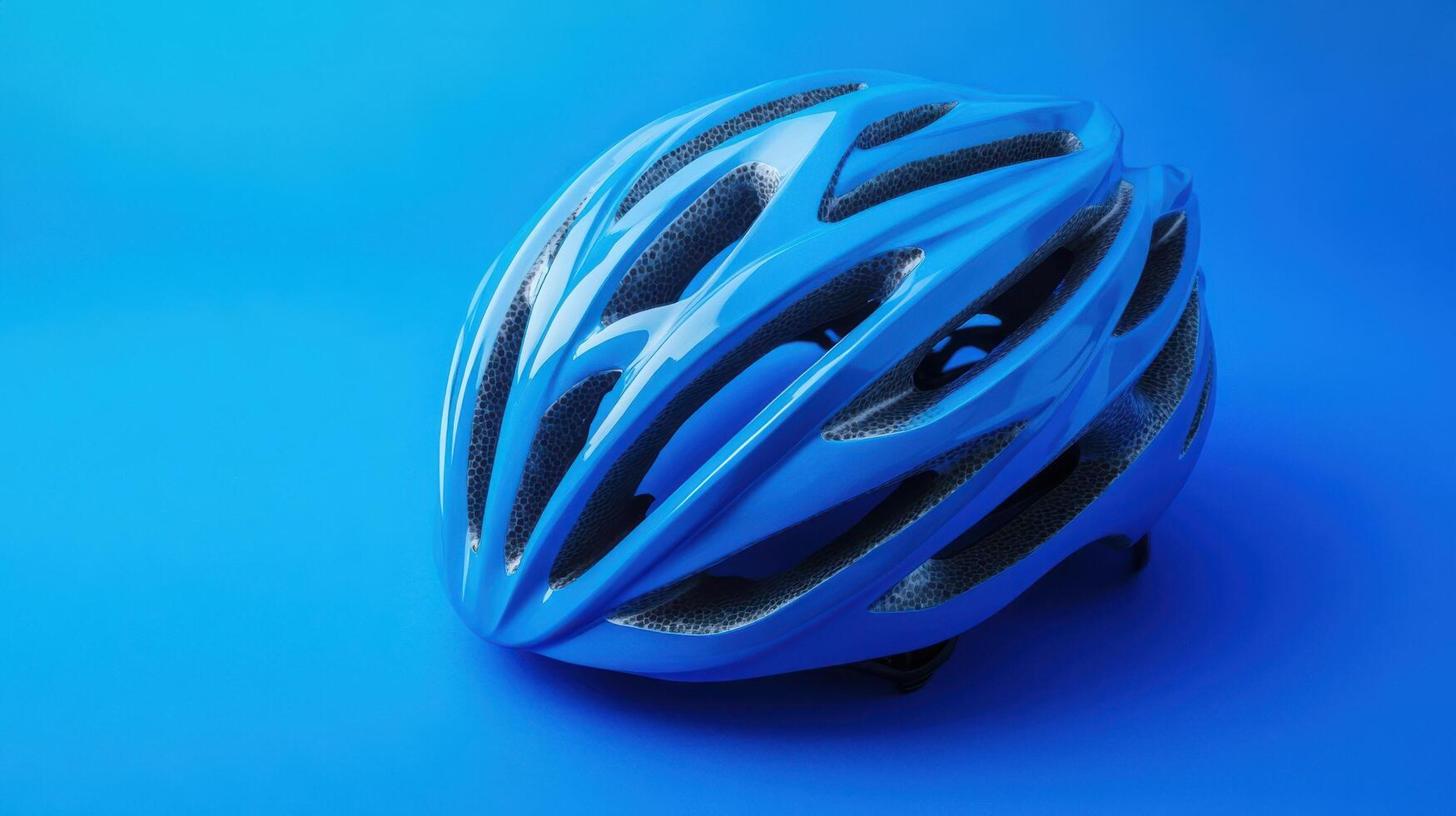 Bright blue cycling helmet on a solid blue background showcasing design and safety features photo