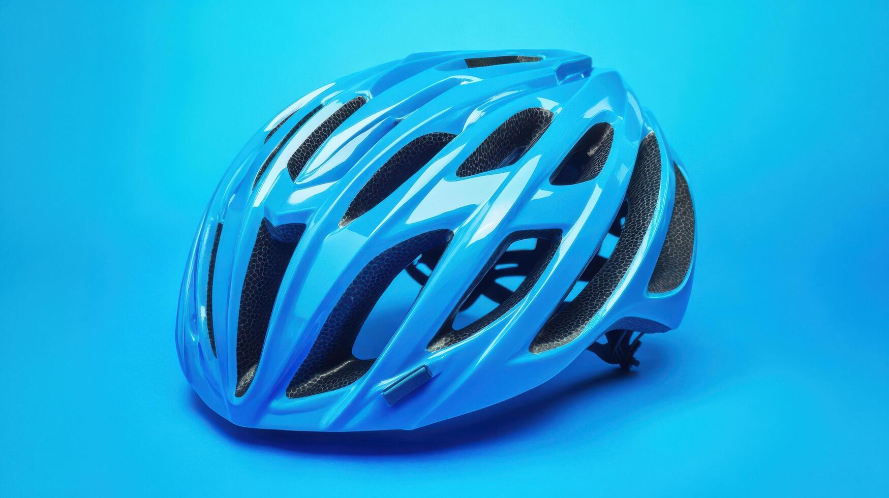 Bright blue cycling helmet displayed against a vibrant blue background for safety promotion and awareness photo