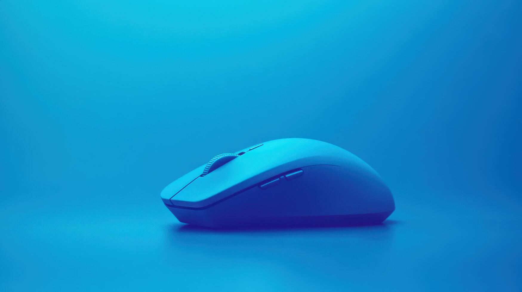 Modern computer mouse displayed on a solid blue background highlighting its sleek design and innovative features photo