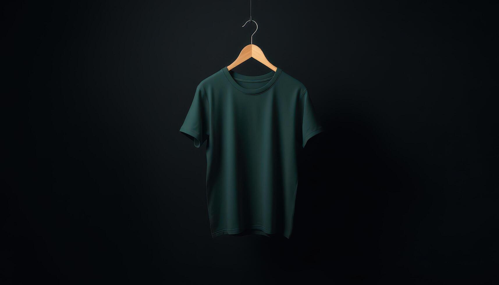 Dark Green TShirt Hanging on a Wooden Hanger Against a Black Background photo