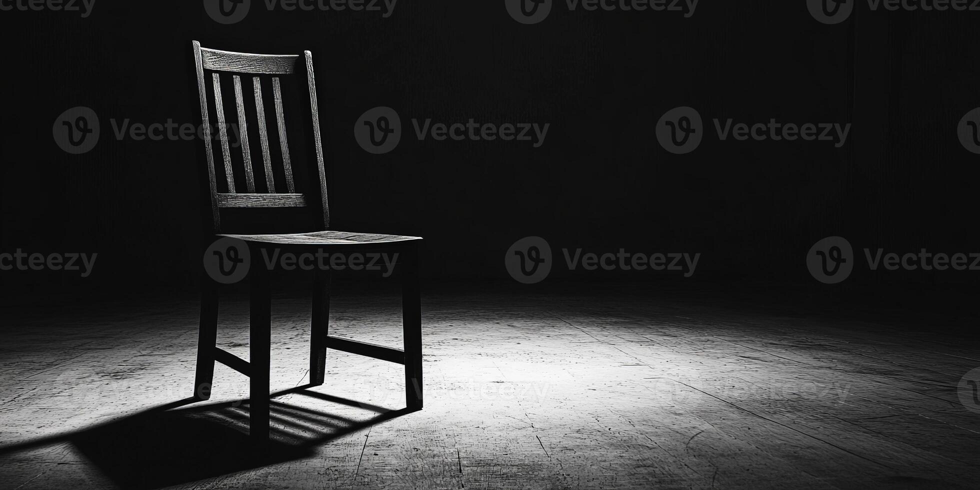 A single chair in a dark room, illuminated by a spotlight. photo