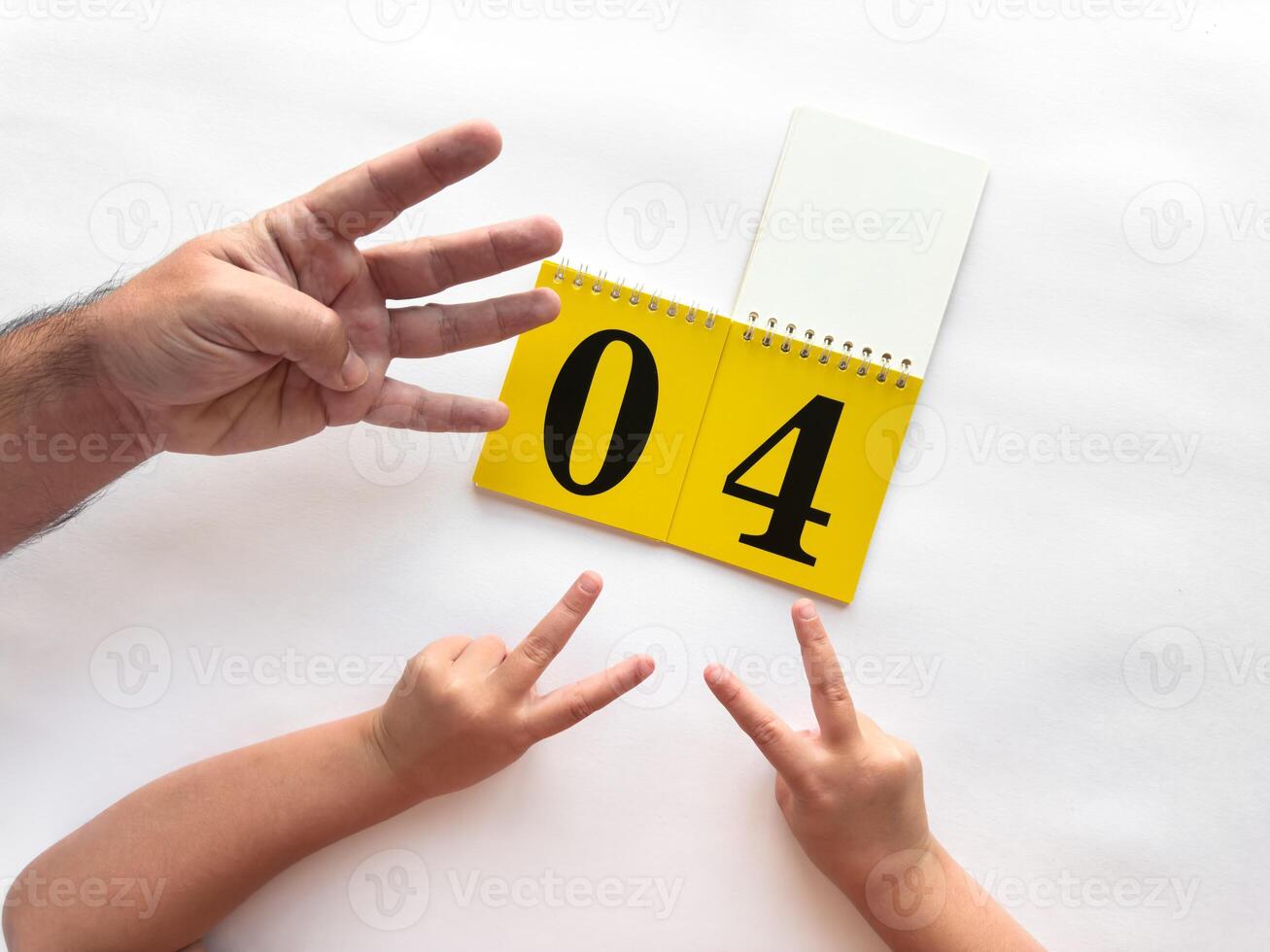 Counting hands with calendar on a white background celebrating number four photo