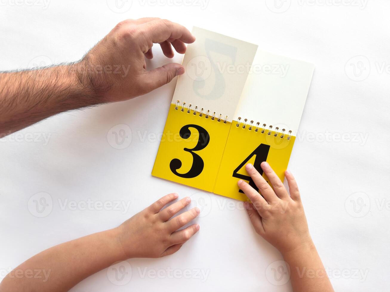 Intergenerational learning with a calendar featuring bold numbers photo
