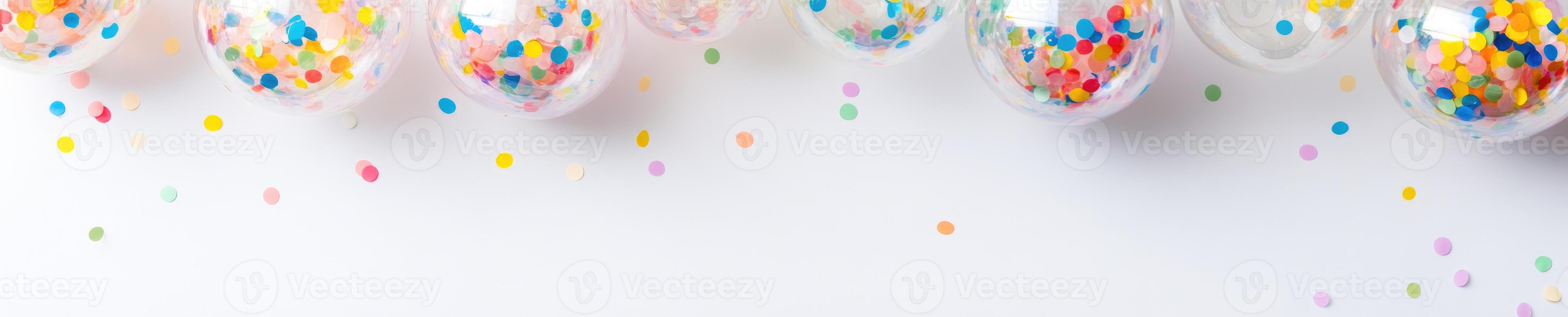 Festive celebration concept with clear balloons filled with colorful confetti photo