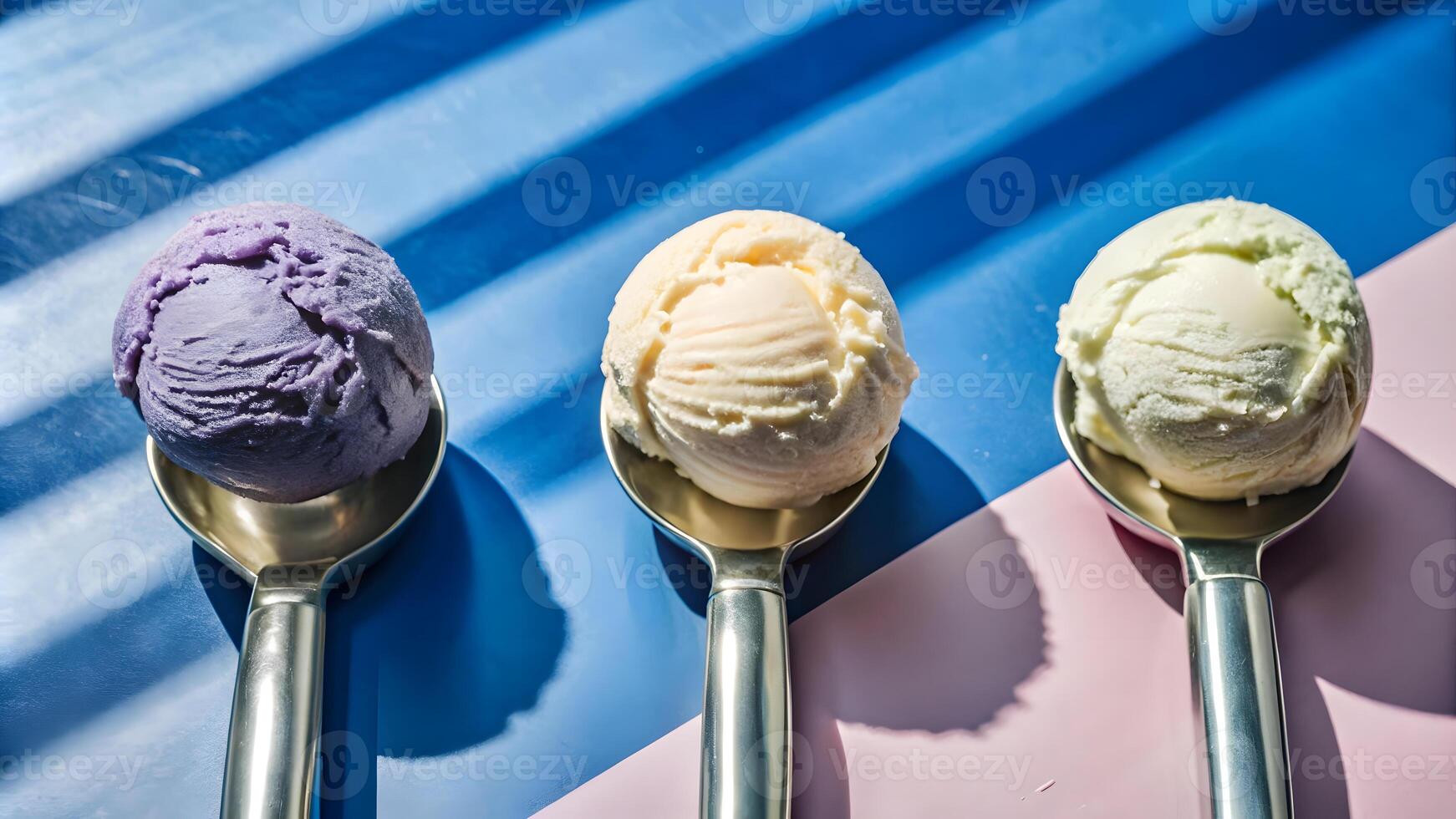 Scoops of colorful ice cream on metallic spoons. photo