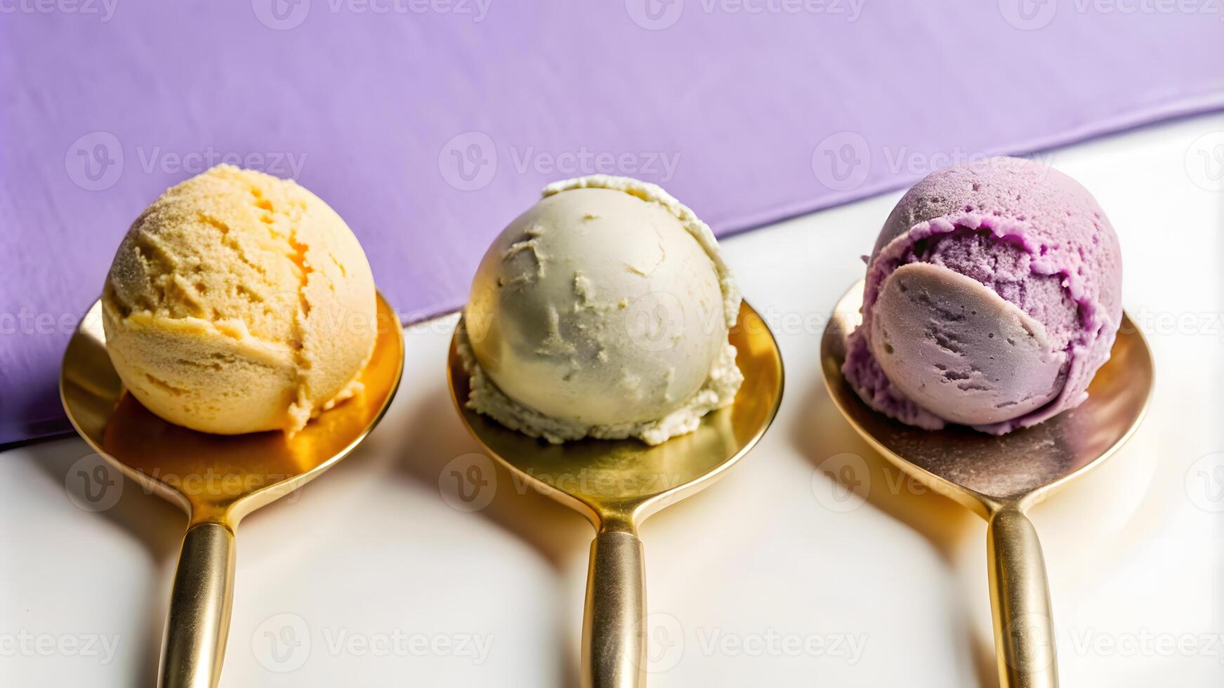 Scoops of colorful ice cream on golden spoons. photo