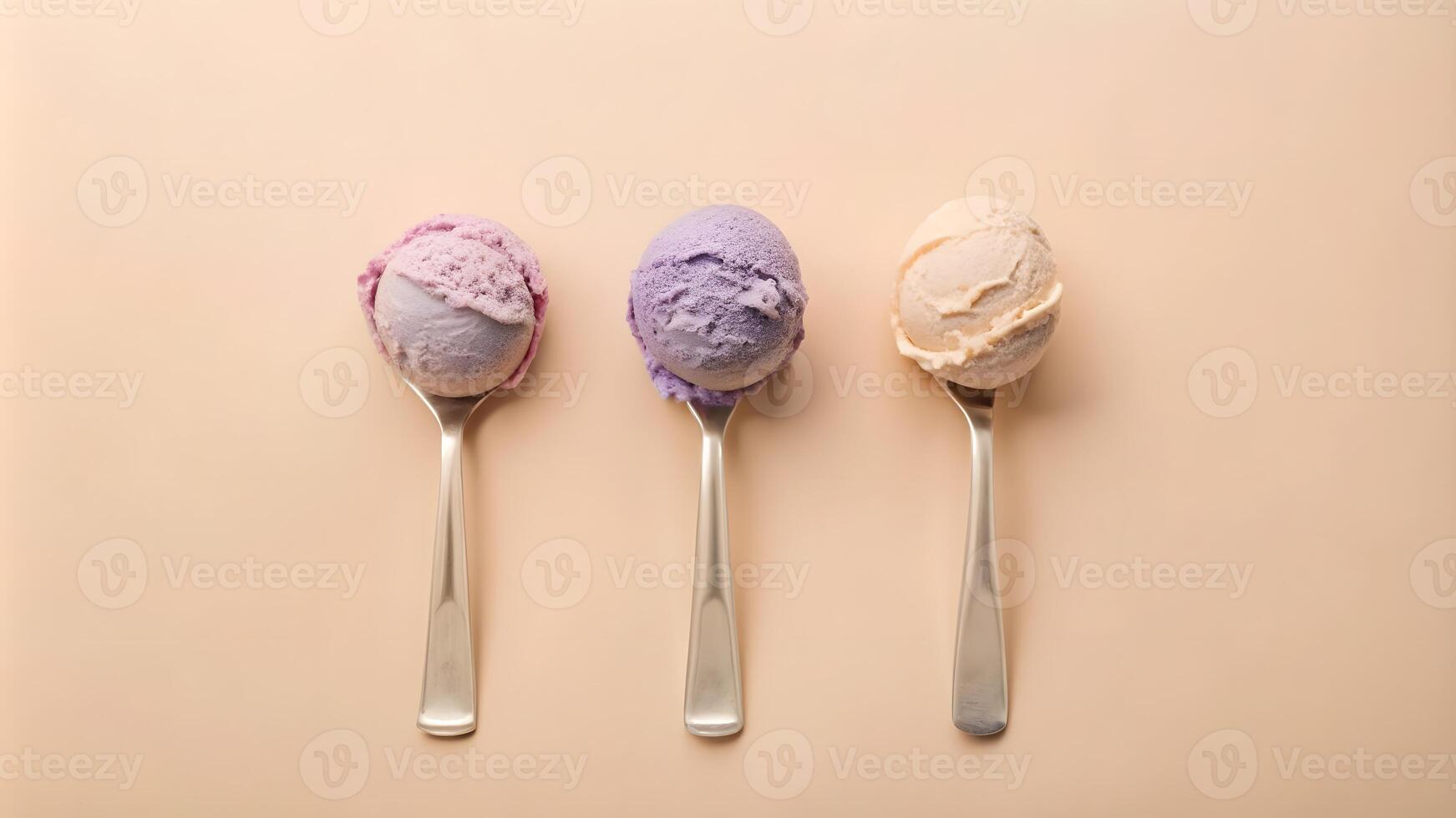 Three scoops of colorful ice cream on silver spoons. photo