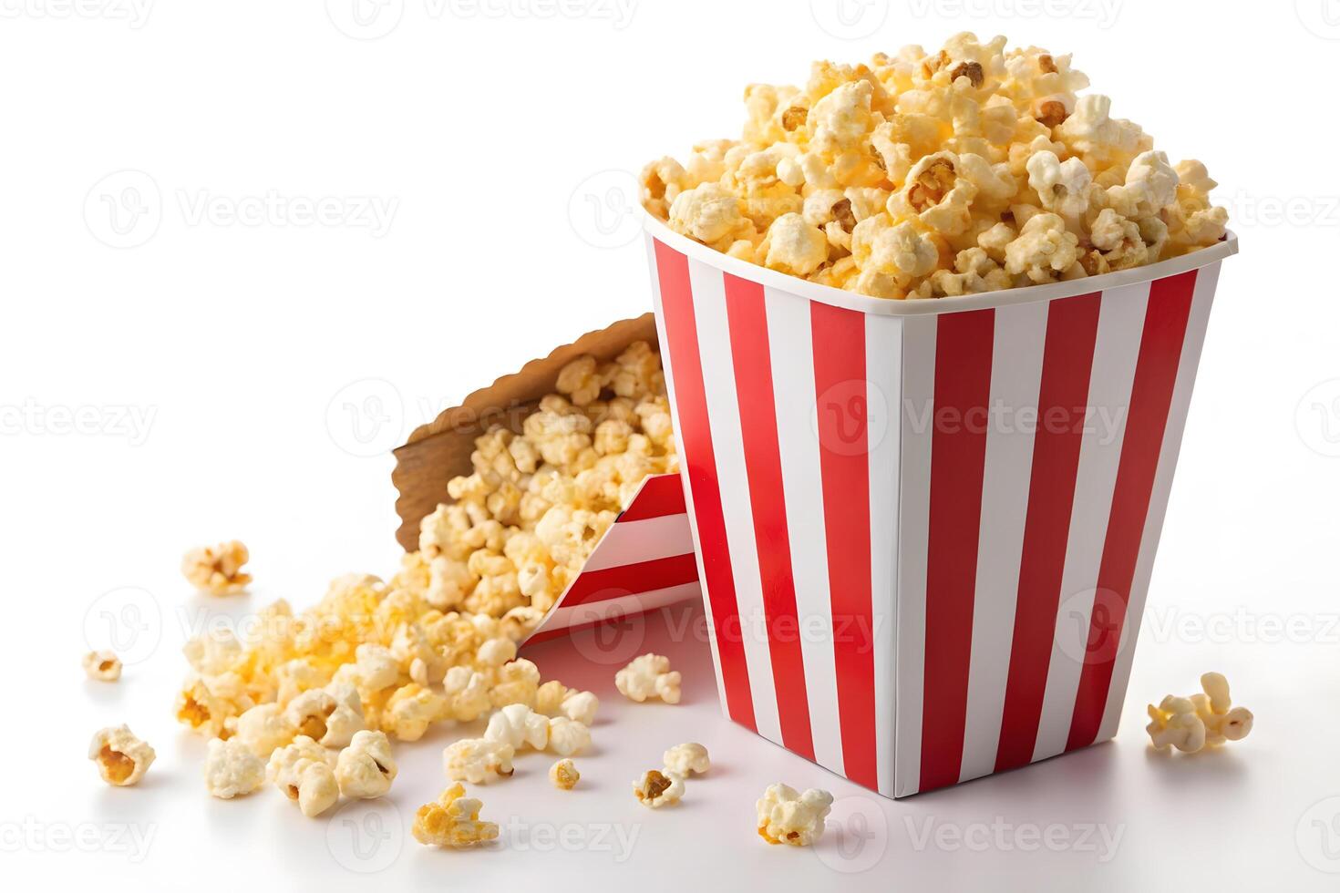 Popcorn in striped box and spilled on white background. photo