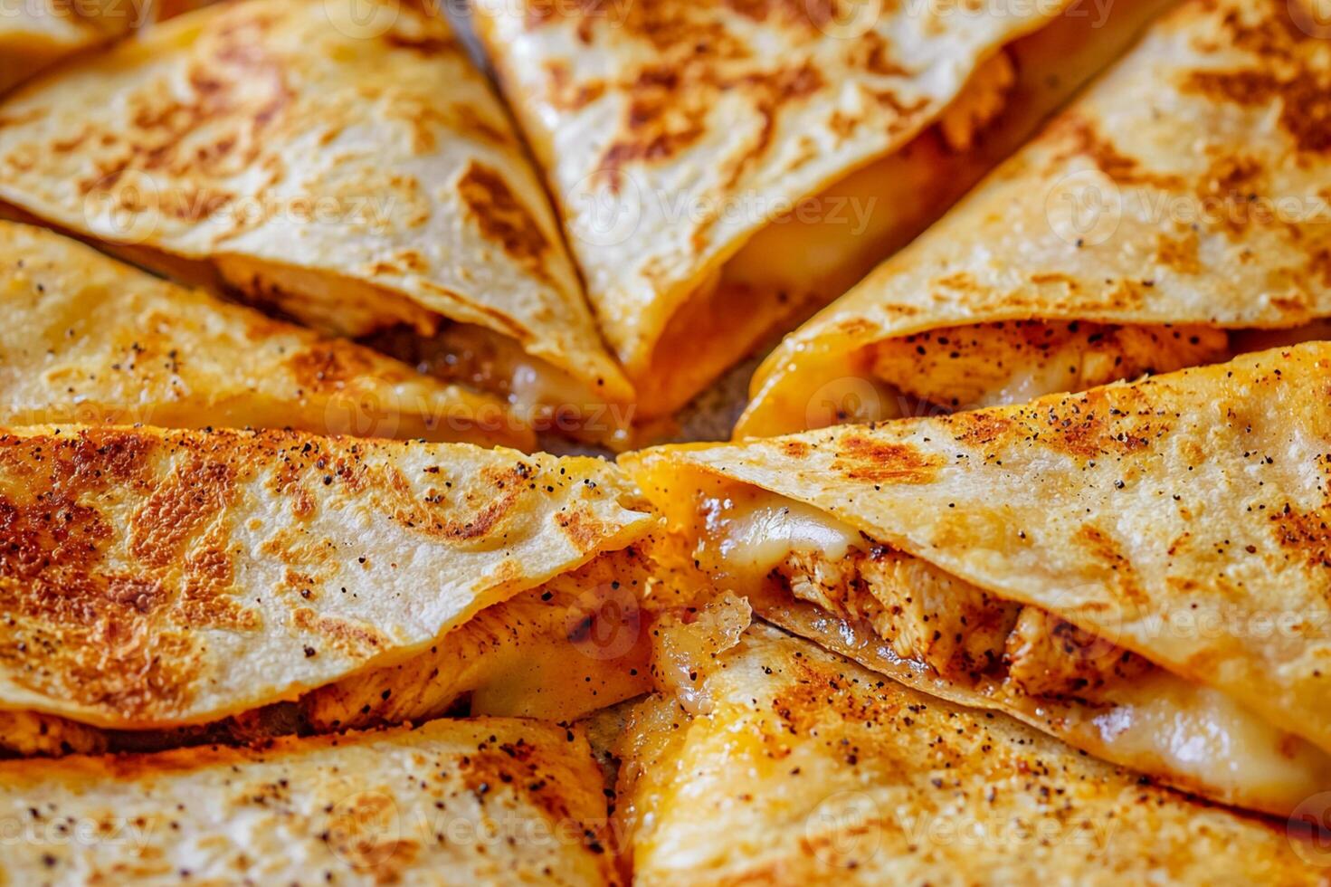 Close-up of crispy quesadillas with melted cheese, seasoned chicken, and golden-brown tortillas photo