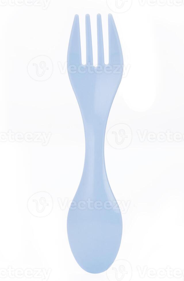 Blue plastic spork combining a spoon and fork in one utensil,isolated on a white background photo