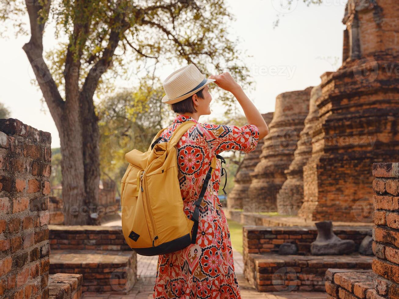 Travel to Ancient City of Ayutthaya, Thailand. woman in dress and backpack photo