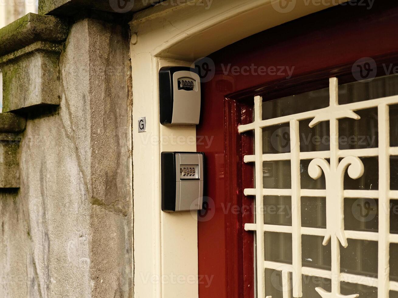 Smart key lock mounted on a wall or door frame for renting apartment. Safe Key Box is used when the guest arrives at the touristic flat and the host can't open the door. Safe access to living space. photo