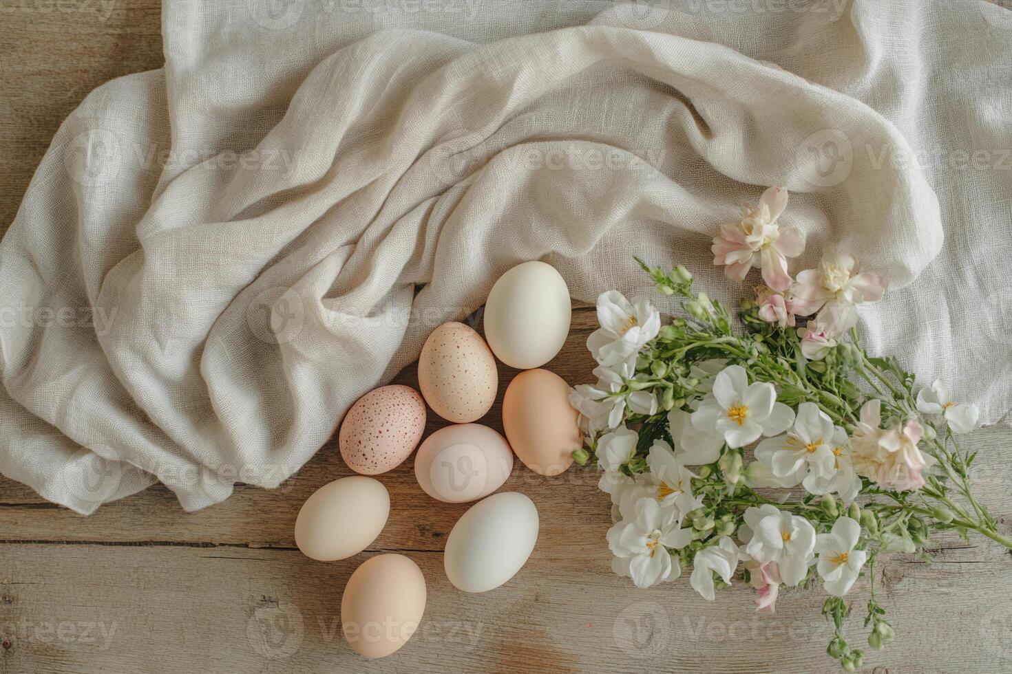 A collection of pale-colored eggs nestled in straw, accompanied by fresh white flowers and soft linen. A serene and organic Easter composition, celebrating spring renewal and elegance. photo