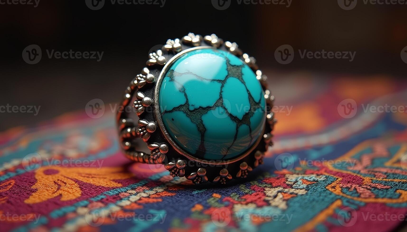 Unique turquoise ring displayed on a vibrant patterned fabric photo