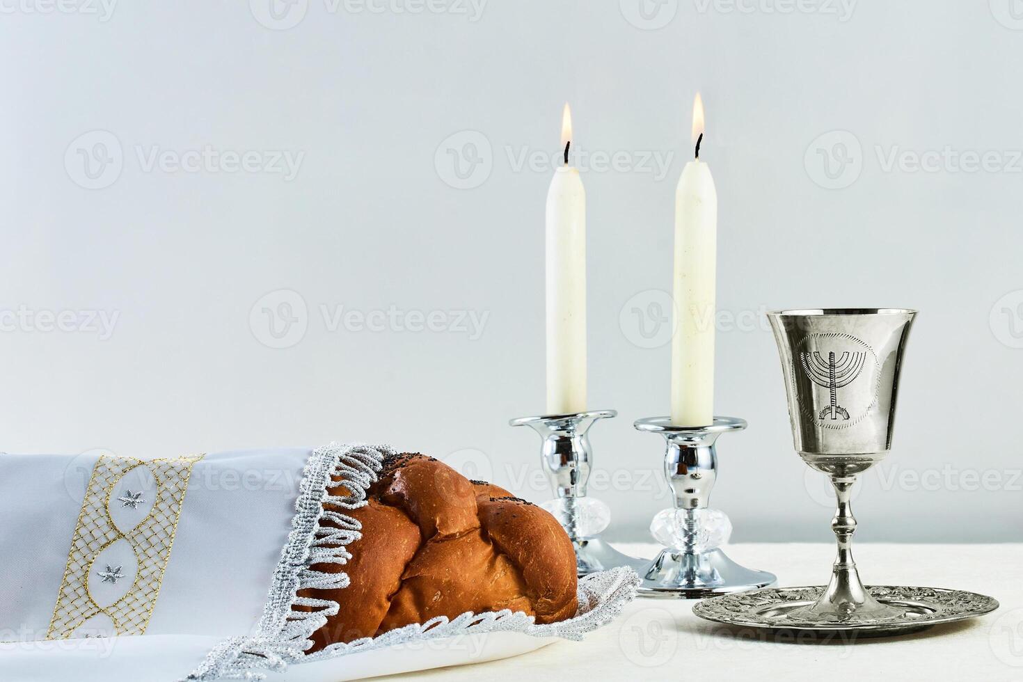 Sabbath Table Setting. Elegant Sabbath table with braided bread, candles, and wine cup. photo