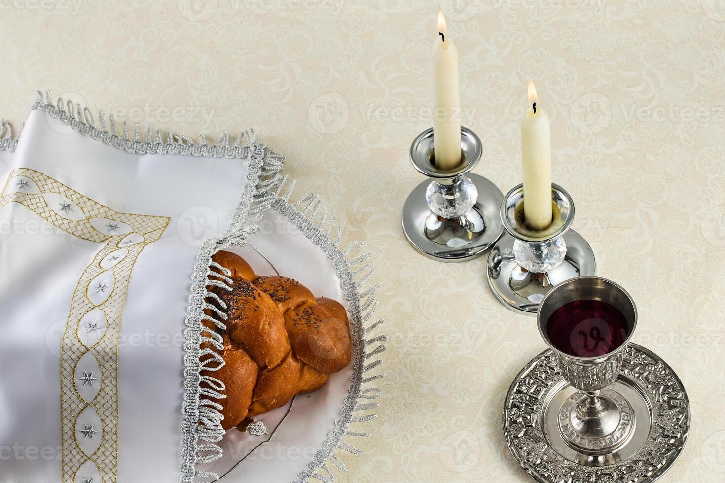 Sabbath Table Setting. Elegant Sabbath table with braided bread, candles, and wine cup. photo