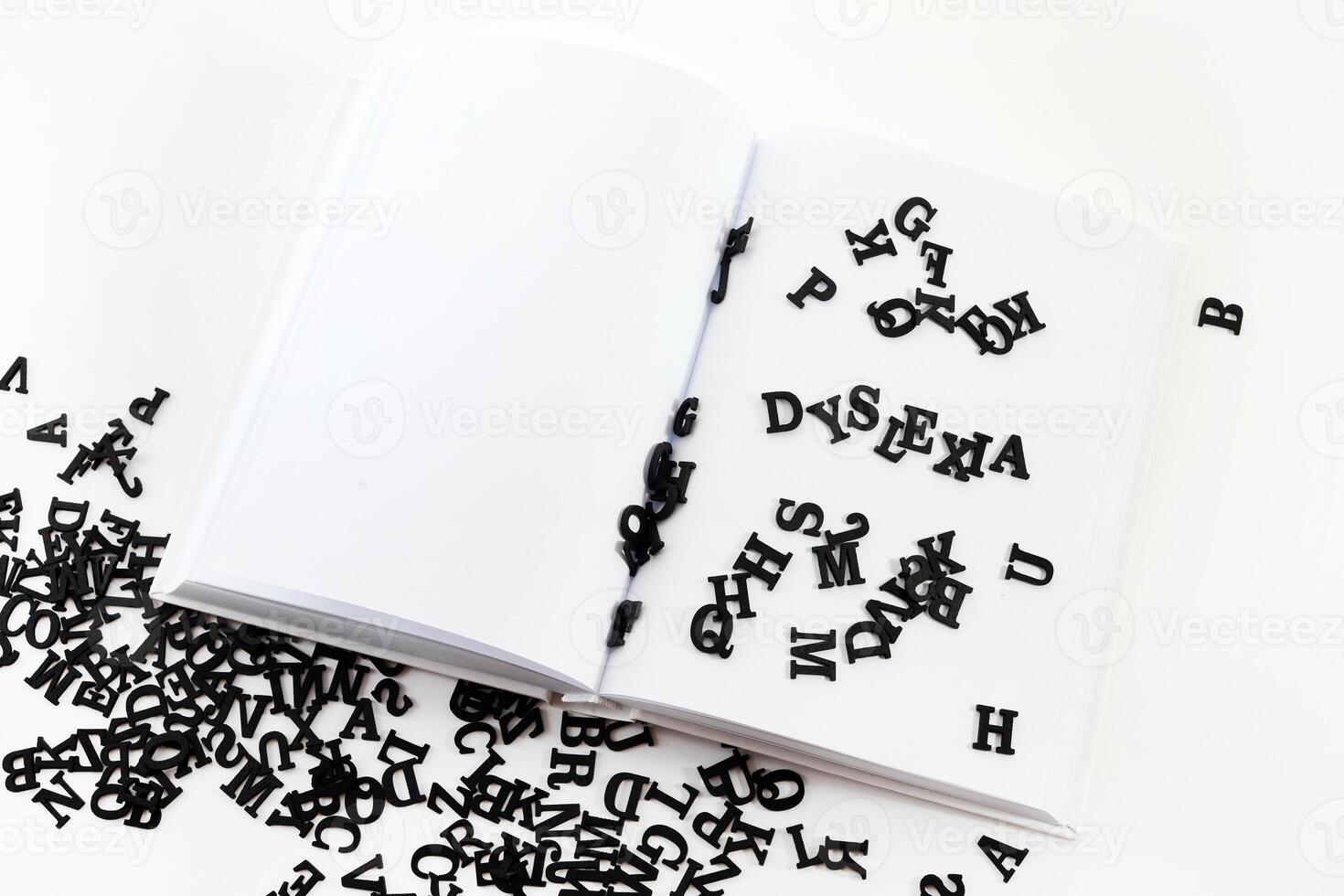 Open book with scattered letters symbolizing dyslexia. Scattered Letters photo