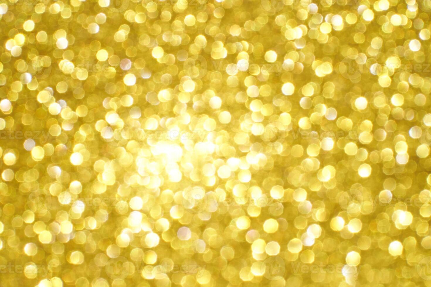 Bright golden bokeh background with soft, blurred light spots creating a warm, glowing atmosphere. photo