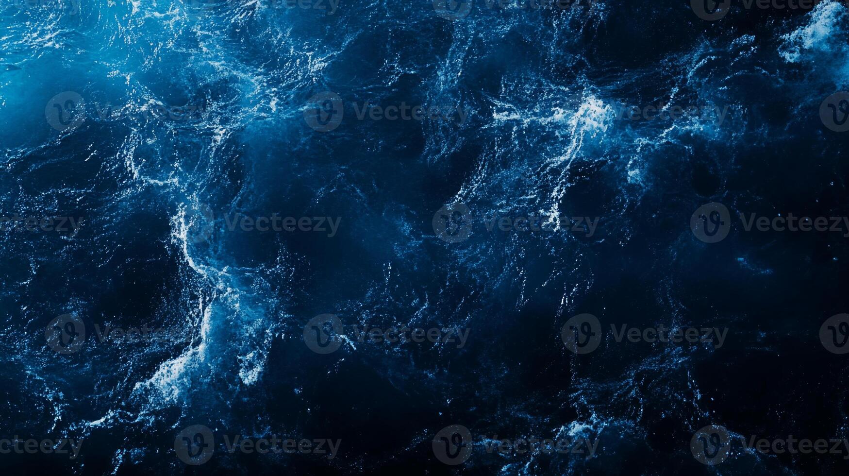 Abstract dark blue water texture with white foam, resembling ocean waves. photo